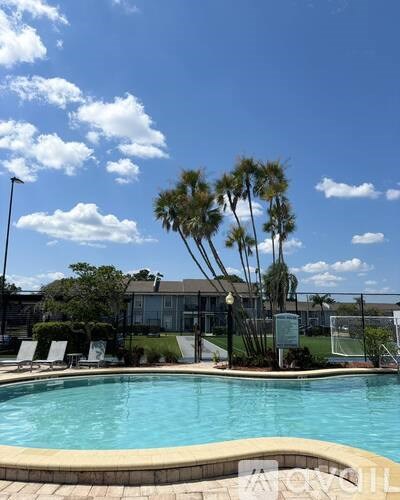 A large white building with a pool in the middle of it.