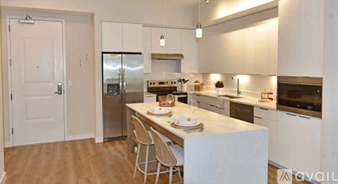 A kitchen with a table and chairs set for two.