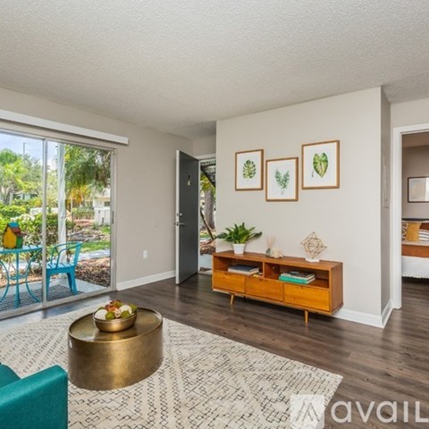 A spacious room with a ceiling fan and large windows.