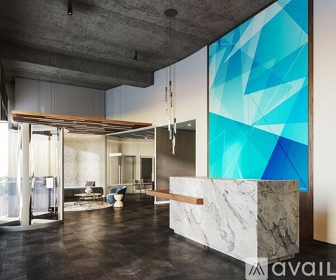 A modern bathroom with a blue and white geometric wall design.