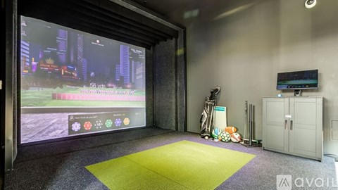 A room with a large screen displaying a video game.