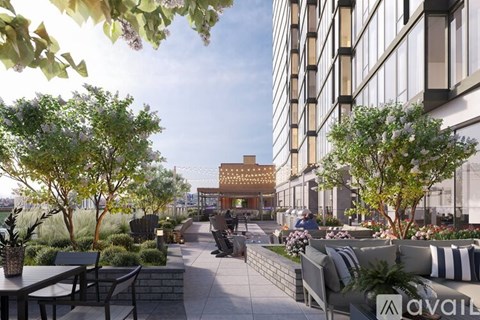 A modern outdoor seating area with a view of a building in the distance.