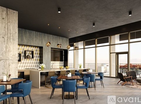 A modern dining room with blue chairs and a wooden table.