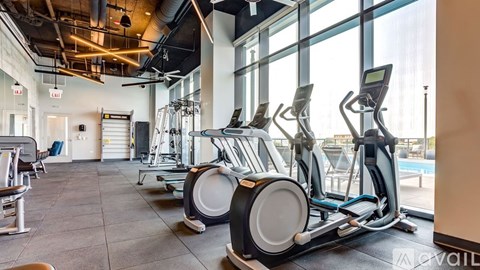 A gym with treadmills and elliptical machines.