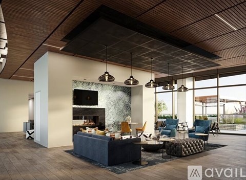 A modern living room with a fireplace and a large window.