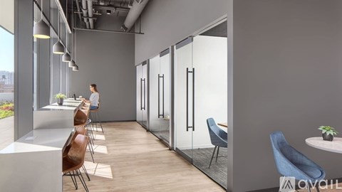 A woman is standing in a room with a row of chairs and a glass wall.
