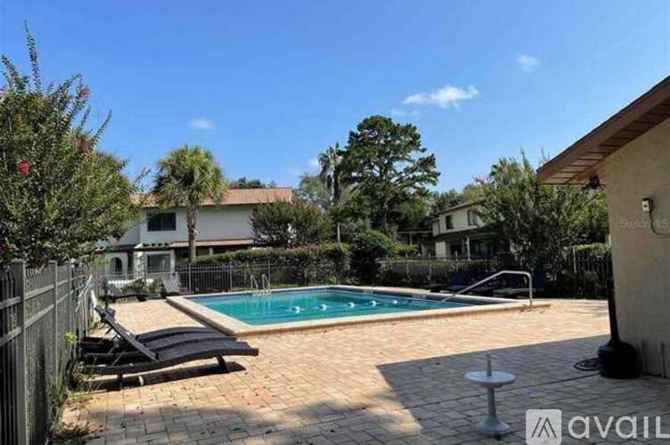 A backyard with a pool and a deck.