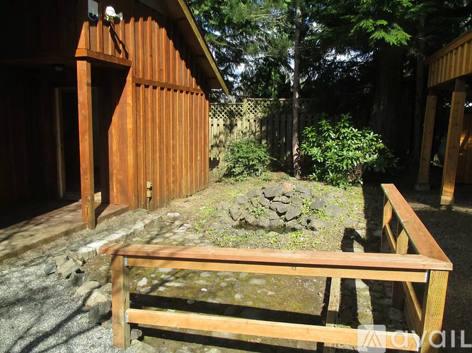 A wooden bench sits in front of a wooden building.