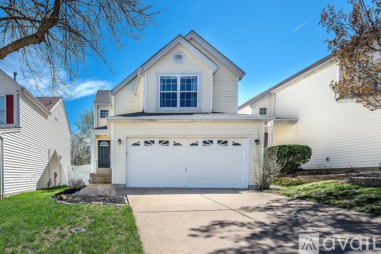 A house with a white garage door is for sale.
