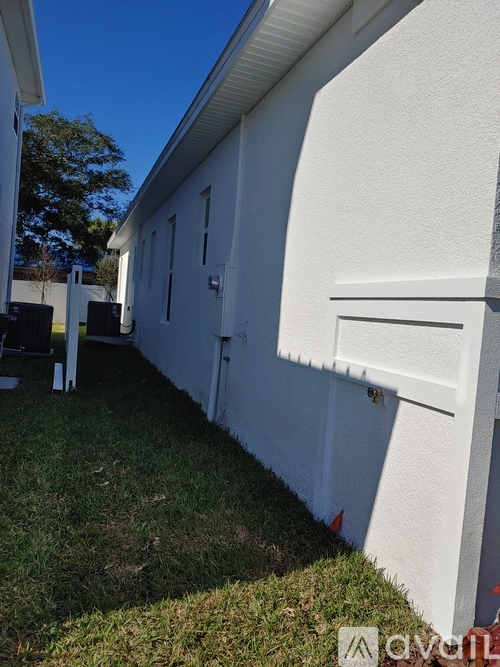 A white building with a door and windows is shown.