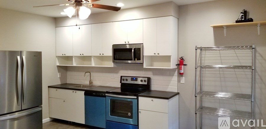 A kitchen with white cabinets and a blue oven.