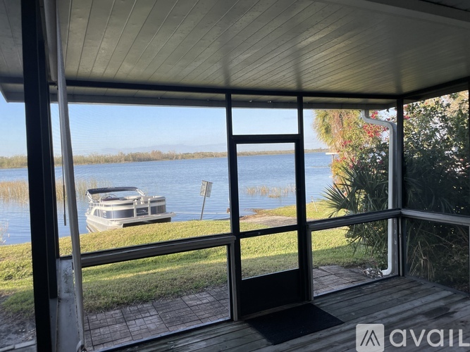 A boat is docked on a lake in the distance.