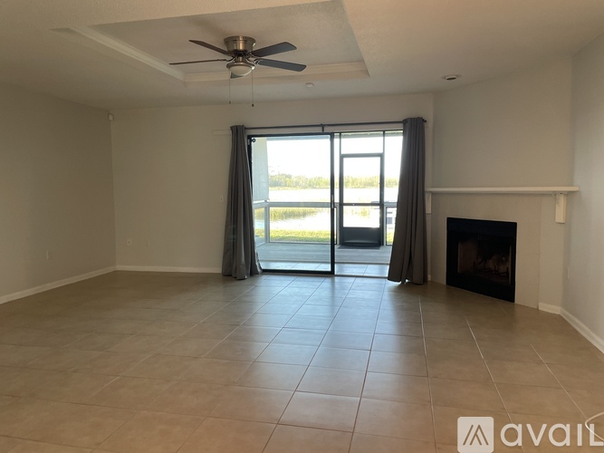 A spacious room with a fireplace and sliding glass doors.