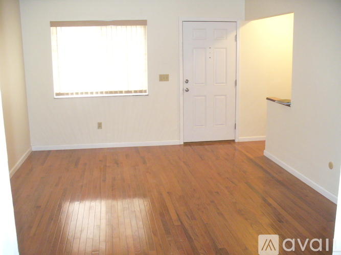 A room with wooden floors and a white door.