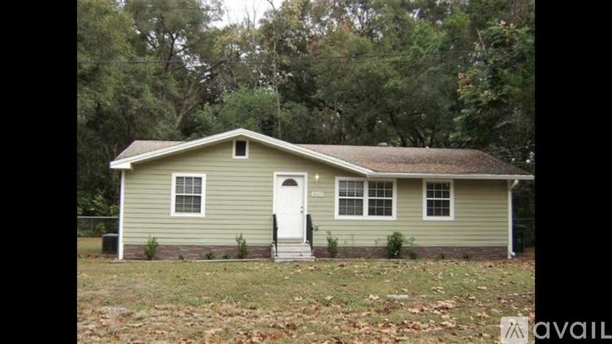 A small house with a white door and two windows is for sale.