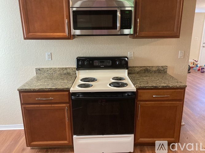 A kitchen with a stove top oven and microwave above it.