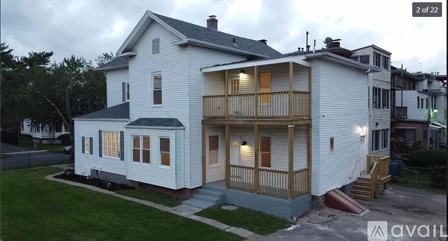A two story house with a balcony on the second floor.
