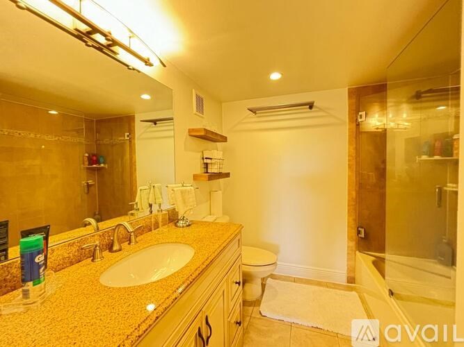 A bathroom with a sink, toilet, and shower.