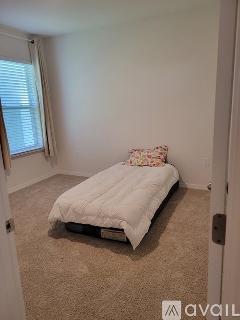 A bedroom with a bed and a pillow.