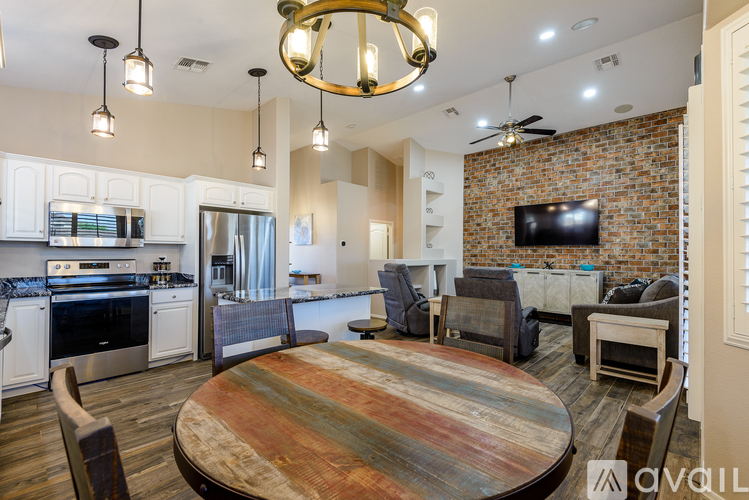A modern kitchen with a wooden table and chairs.