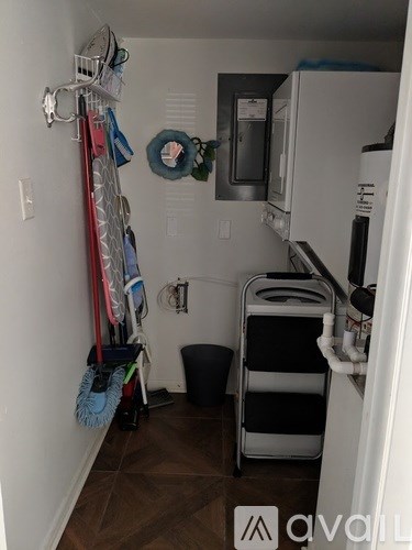 A kitchen with a white fridge and a white wall.