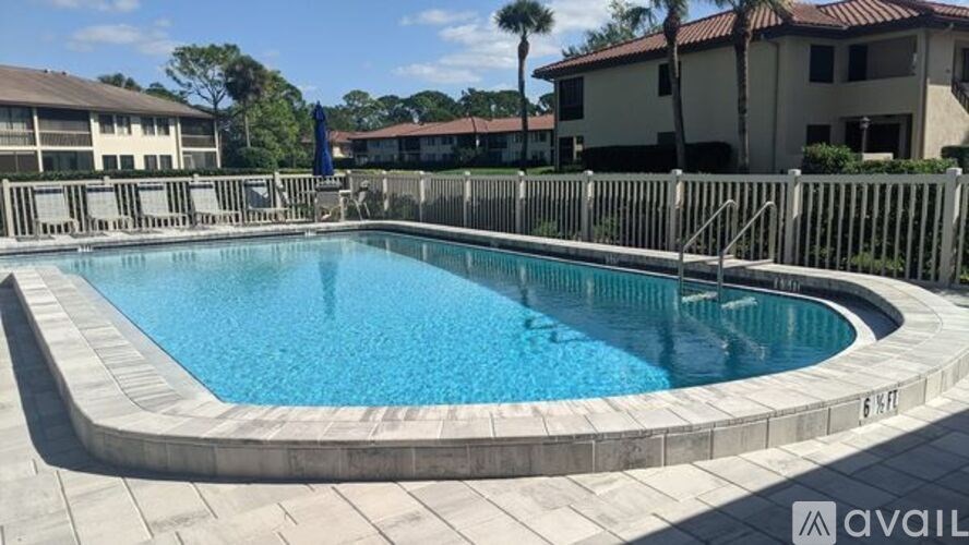 A swimming pool surrounded by a concrete border.