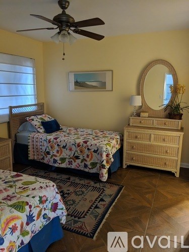 A bedroom with a bed, dresser, and mirror.