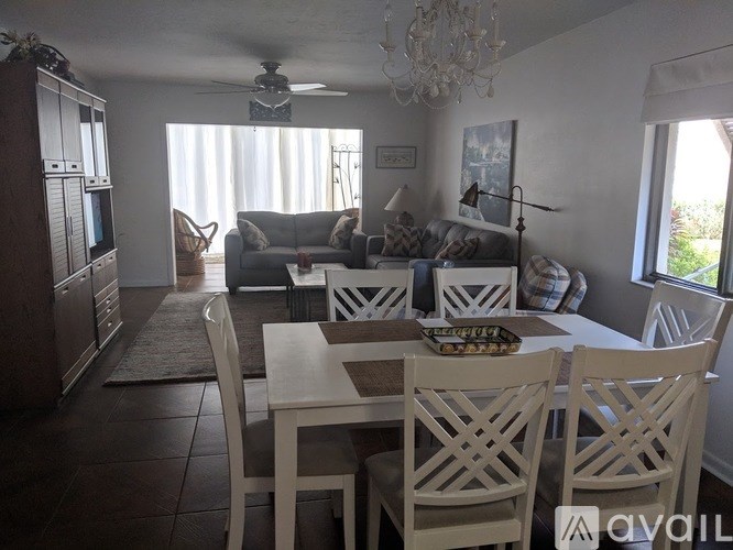 A dining room with a table set for four.