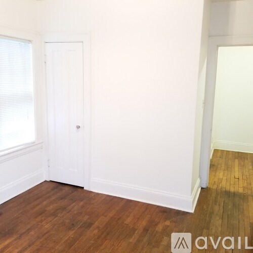 A room with wooden floors and white walls.