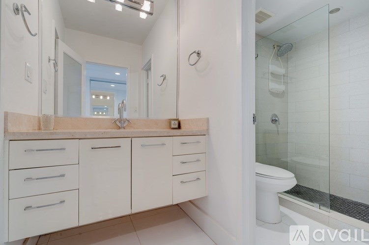 A white bathroom with a walk in shower.