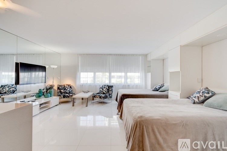 A bedroom with two beds and a sofa.