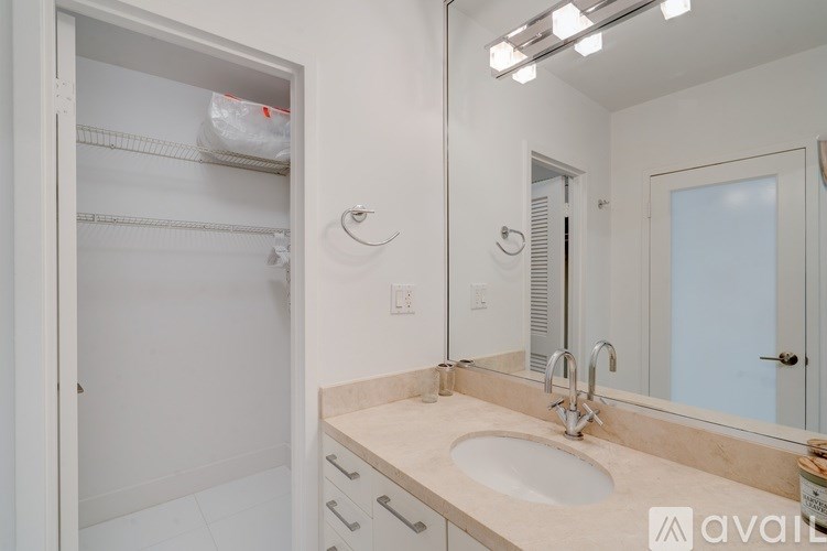 A bathroom with a sink, mirror, and medicine cabinet.