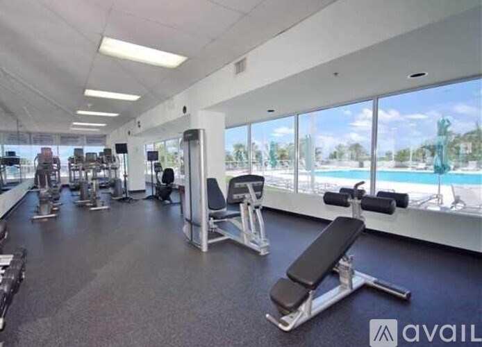 A gym with a variety of equipment including weights and machines.