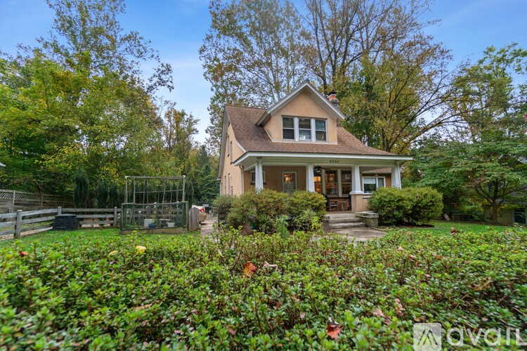 A house with a well-maintained garden in front.