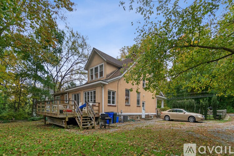 A house with a car parked in front of it.