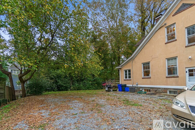 A house with a driveway covered in leaves.