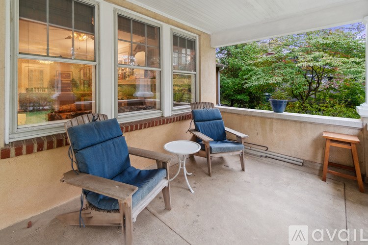 A patio with two chairs and a table.