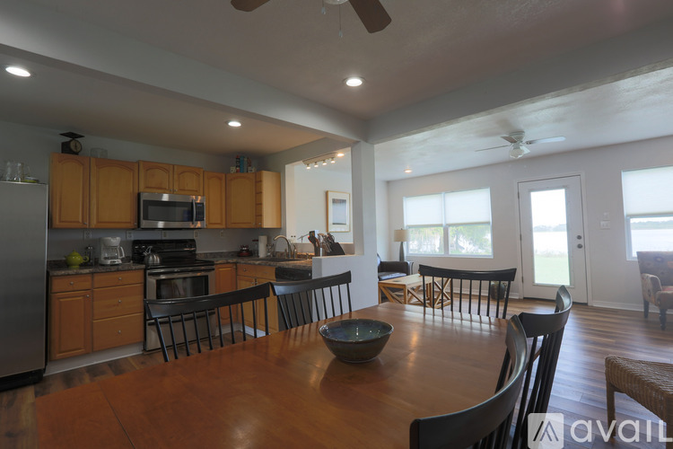 A modern kitchen with wooden cabinets and a large island.