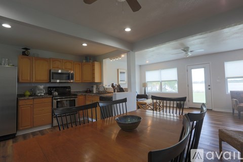 A modern kitchen with wooden cabinets and a large island.