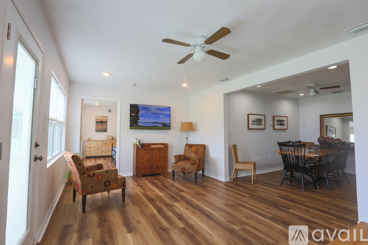 A living room with a television and a dining table.