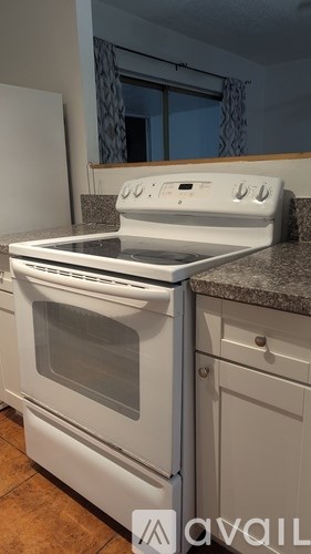 A white oven with a stove top sits on a kitchen counter.