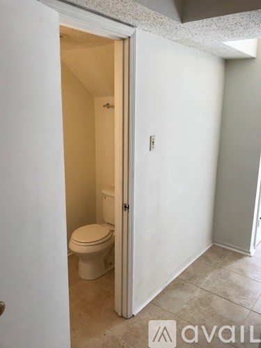 A bathroom with a toilet and a door.