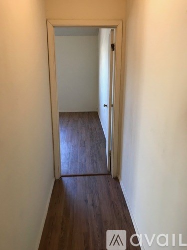 A hallway with a door at the end.