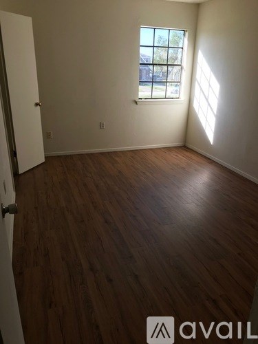 A room with wooden floors and a window.