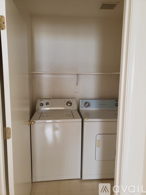 A small laundry room with a washer and dryer.