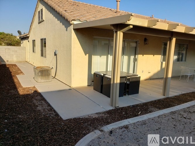 A house with a patio and a covered entrance.