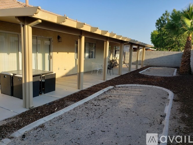 A row of houses with a palm tree in the background.