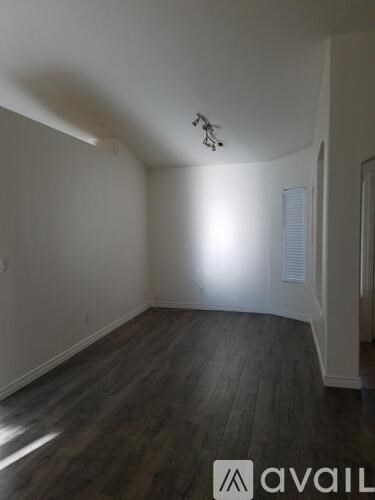 A room with wooden floors and white walls.