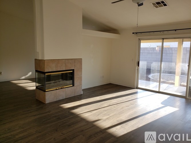 A room with a fireplace and sliding glass doors.