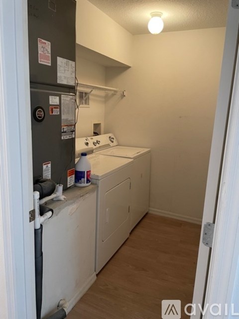 A small kitchen with a fridge, dishwasher and a stove top.